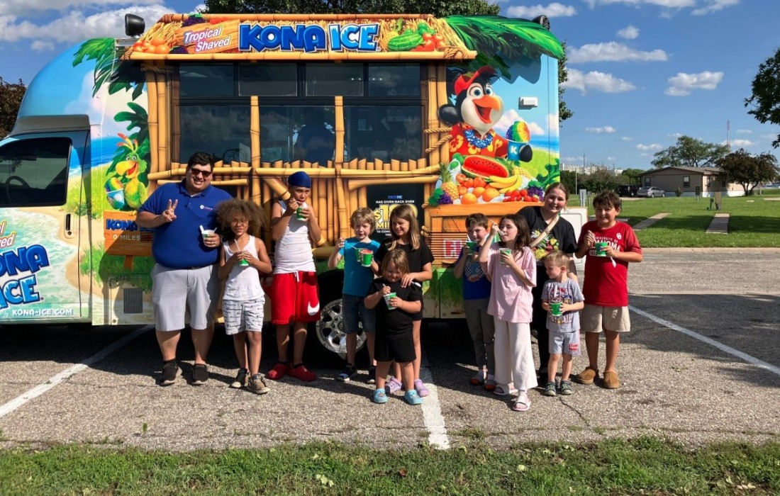 Bayshore residents gather in front of the Kona Ice shaved ice truck in summer 2025