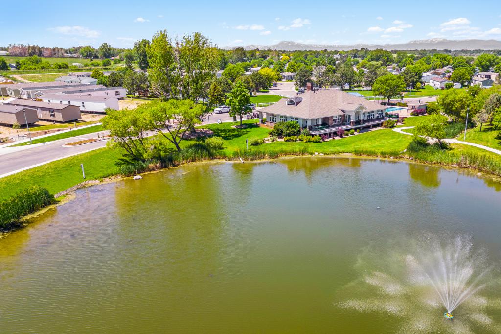 Aerial view of Stoneybrook Pointe manufactured home community including a pond