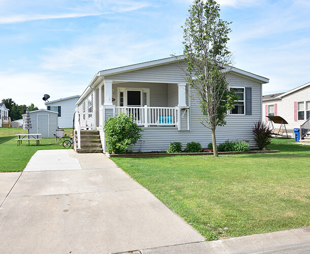 a manufactured home near you with paved drive and parking space and a nice front porch